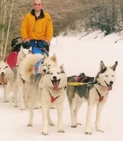 Seven leading a sleddog team with her dad, Vader